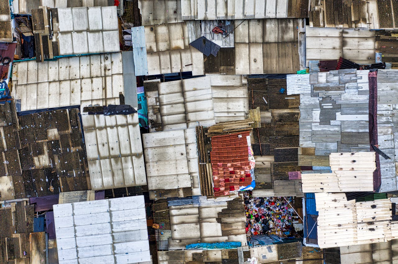 services-02 Aerial view of densely packed rooftops in a Jakarta slum, showcasing urban density.